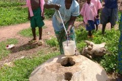 Woman_showing_off_water_from_well